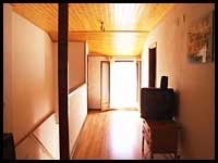 Photo of the hallway leading to the bedrooms and balcony